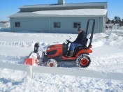 Dad tractor snow blowing
