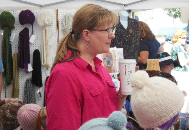 Laura, our Jewelry artist, enjoying some Java and the children's parade.