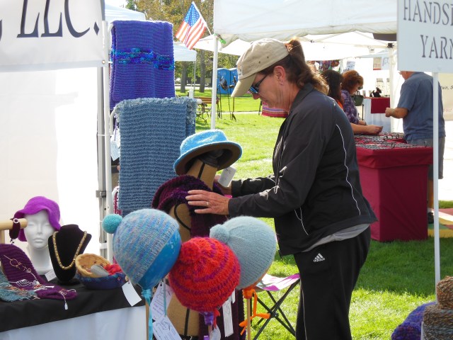 Aunt Geri arranges hats at the Summerset Festival.